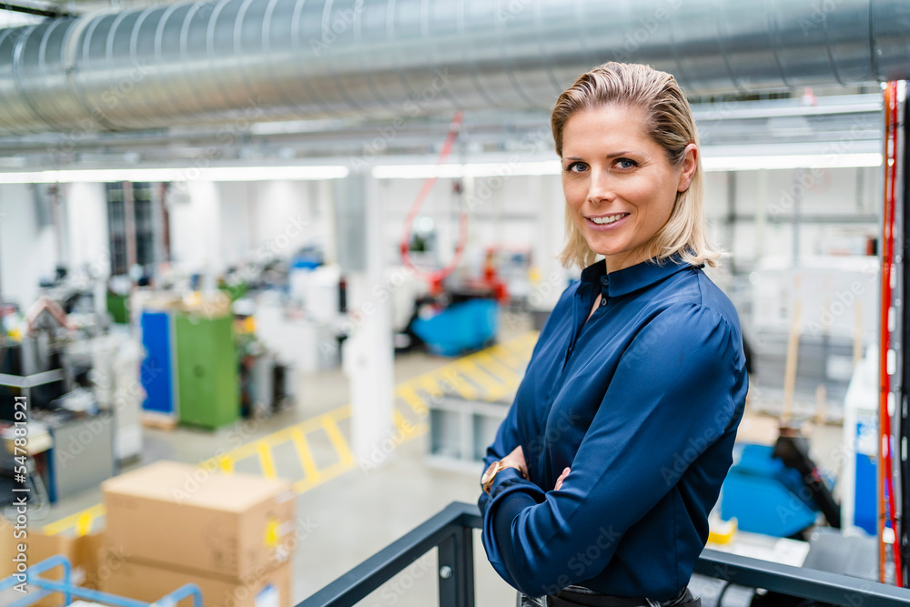 confident-businesswoman-wearing-blue-shirt-standing-with-arms-crossed-at-factory-stockpack-adobe-stock Confident businesswoman wearing blue shirt standing with arms crossed at factory