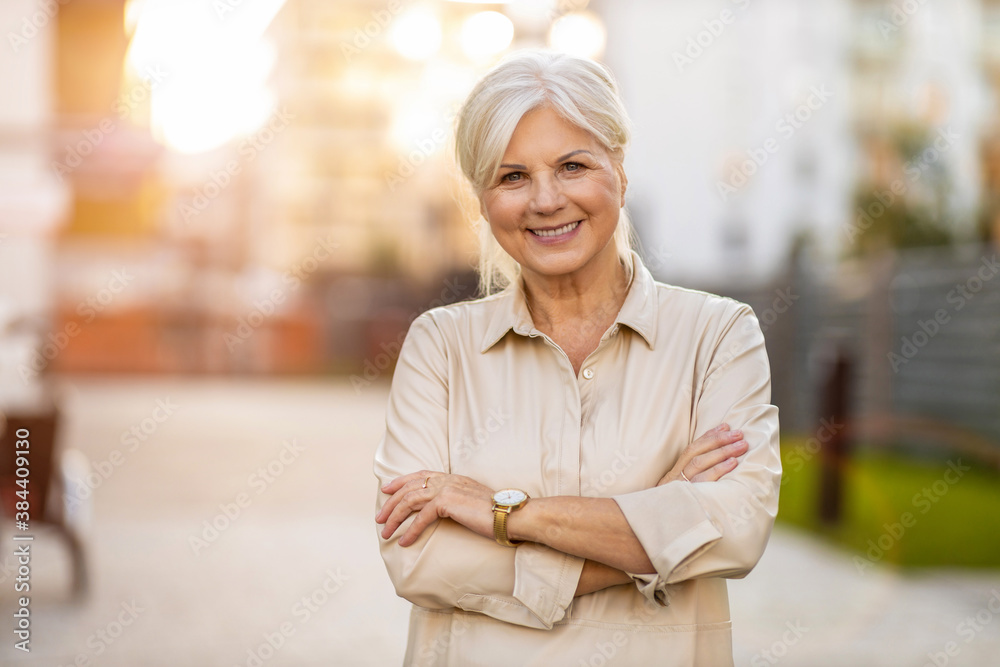 portrait-of-a-confident-senior-woman-in-the-city-at-sunset-stockpack-adobe-stock Portrait of a confident senior woman in the city at sunset